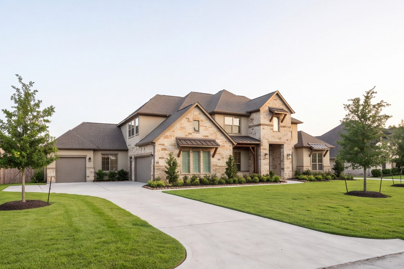 wide new custom home on a Katy lot, late afternoon, driveway and lawn